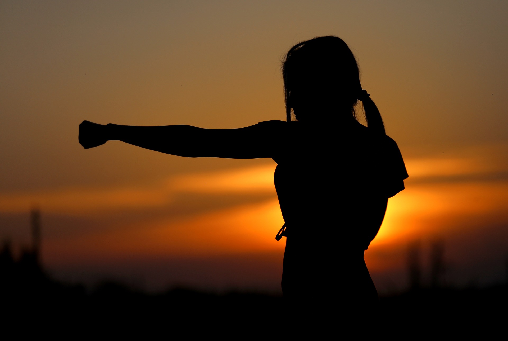 Active woman in front of sunset